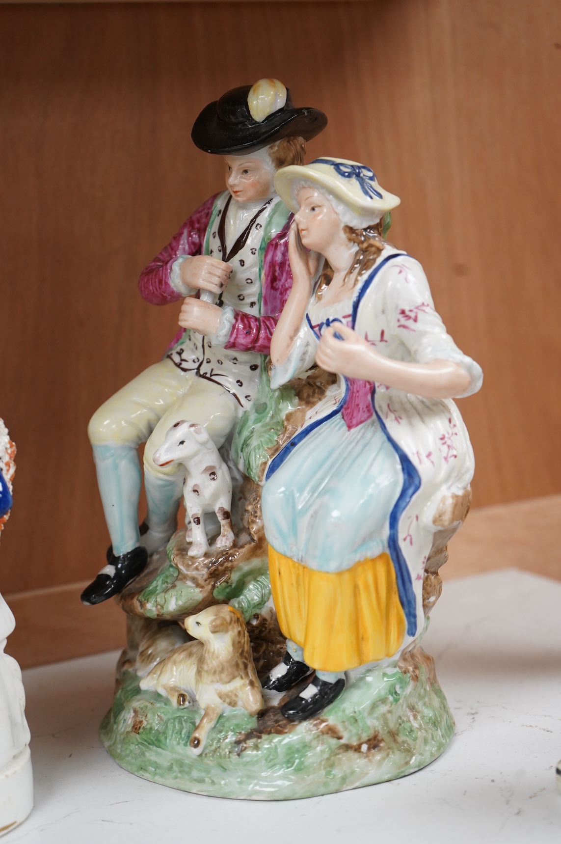 A Ralph Wood style group and three Staffordshire figures, largest 26cm high